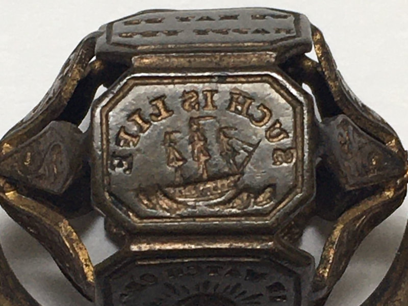 Detail of a small rolling fob seal with the reversed image of a ship and the motto 'such is life'.