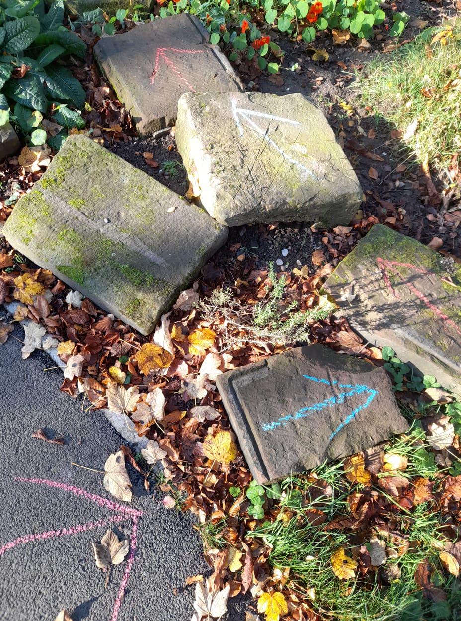 Chalk arrows on the ground in the Platt Hall garden